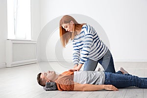 Woman practicing first aid on unconscious man