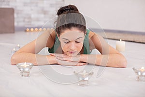 woman practicing homemeditation surrounded with candles