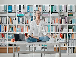 Woman practicing meditation on a desk