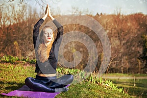 Woman practicing morning meditation in nature