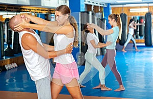 Woman practicing painful technique for eyes of opponent during self-defense training
