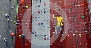 Woman practicing rock climbing in fitness studio 4k