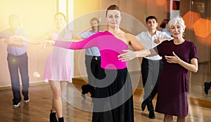 Woman practicing slow foxtrot movements during dance class