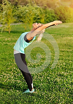 Woman practicing Standing Backbend Pose