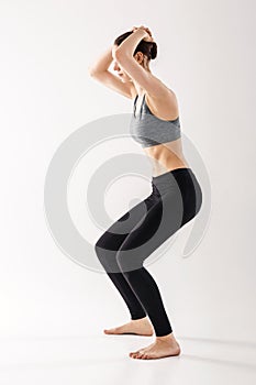 Woman practicing Uddiyana Bandha technique