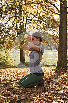 Woman practicing yoga in autumn in prayer posture