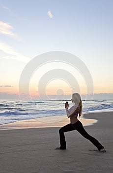 Woman Practicing Yoga on Beach Sunrise or Sunset