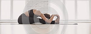 Woman practicing yoga in class, young woman doing exercises at home panoramic banner.