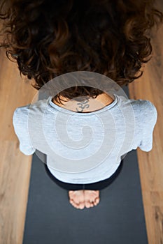Woman practicing yoga in diamond pose, Vajrasana, Thunderbolt Pose in studio, hands on the knees