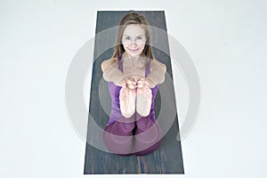 Woman practicing yoga, doing Paripurna Navasana exercise, boat pos