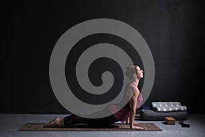 Woman practicing yoga, doing urdhva mukha svanasana, upward facing dog pose