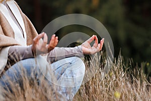 Woman practicing yoga exercise in lotus position