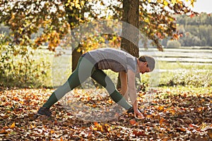 Woman practicing yoga in fall