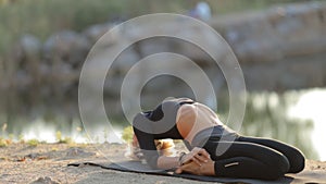 Woman Practicing Yoga In Front Of The Sea