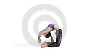 Woman practicing yoga Kapotasana, Pigeon Pose