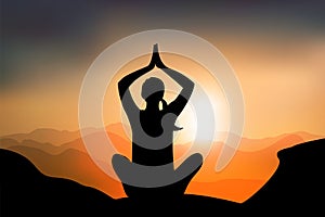 Woman practicing yoga lotus pose on mountain with sunset, calm environnement for breathing, concentrate and recovering energy photo