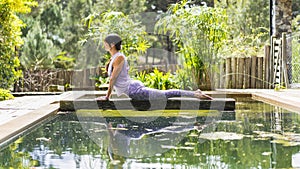 Woman practicing yoga, lying in Cobra pose (Bhujangasana exercise) outdoors