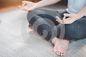 Woman practicing yoga meditation at home