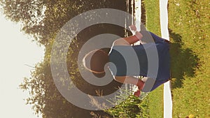 Woman practicing yoga meditation sitting on yoga mat at sunrise. Vertical video