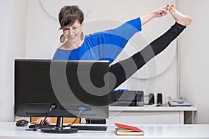 woman practicing yoga in the office