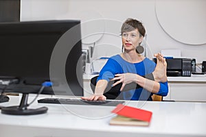 woman practicing yoga in the office