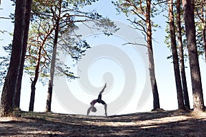 woman practicing yoga outdoors, in harmony with nature