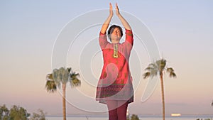 Woman practicing yoga outdoors during morning meditation.Peaceful Meditation in morning sunny day for good health.in