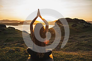 Woman practicing yoga outdoors. Spiritual harmony and well-being concept