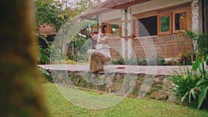 Woman practicing yoga in a peaceful garden setting