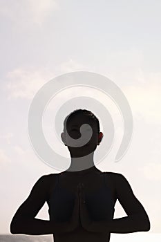 woman practicing yoga in pray position