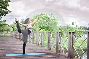 Woman practicing yoga relax in nature and blue sky background