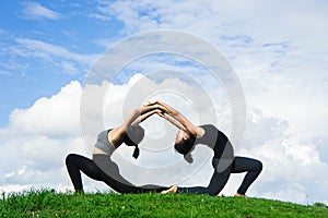 Woman practicing yoga relax in nature and blue sky background