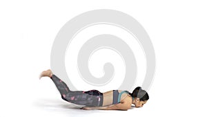 Woman practicing yoga Shalabhasana pose