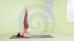 Woman practicing yoga sholder stand pose