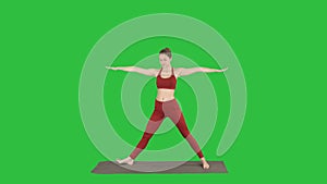 Woman practicing yoga, standing in Extended Side Angle exercise, Utthita parsvakonasana pose on a Green Screen, Chroma