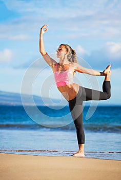 Woman practicing yoga at sunset