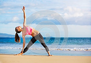 Woman practicing yoga at sunset