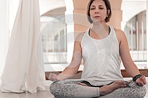 Woman practicing Yoga with their eyes closed meditate in silence.