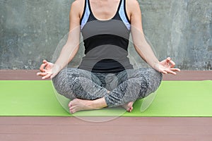 woman practicing yoga in urban / wall background