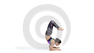 Woman practicing yoga Vrschikasana, Scorpion pose