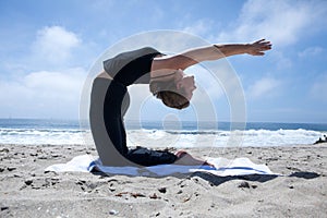 Woman Practicing Yogo at the Beach