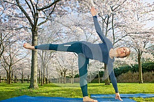 Woman practising a half moon pose