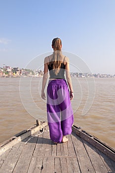 Woman practising standing yoga meditation on the boat
