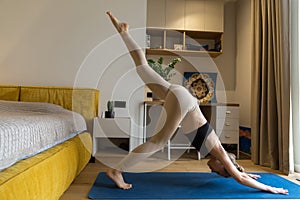 woman is practising yoga at home