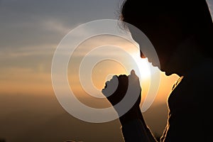 Woman Pray for god blessing to wishing have a better life. begging for forgiveness and believe in goodness. Christian life crisis