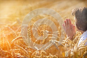 Woman pray for a rich harvest photo