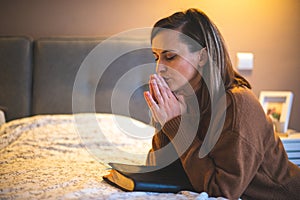 Woman with pray and worship god in her bedroom
