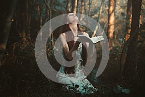 Woman praying alone in the forest