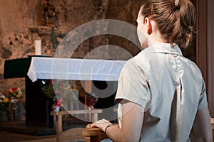 Woman praying at an alter