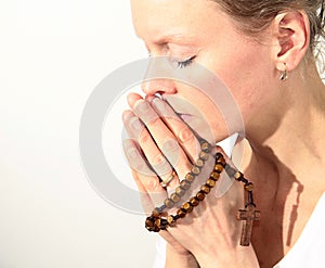 Woman praying with cross in her hands